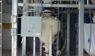 Dense phase pneumatic conveying of ground calcined alumina from a BulkBuster™ bulk bag unloader to a surge bin
