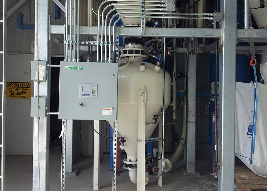 Dense phase pneumatic conveying of ground calcined alumina from a BulkBuster™ bulk bag unloader to a surge bin