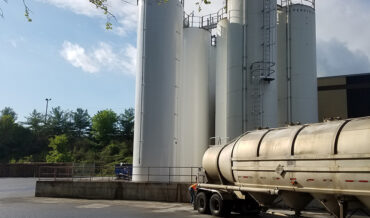 Dense phase pneumatic conveying of soda ash from a silo to a receiving hopper