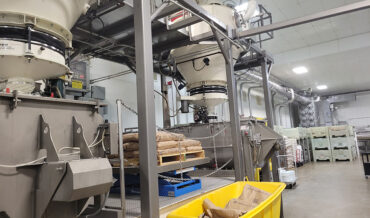 Dense phase pneumatic conveying of sugar from a bag dump station to mixers