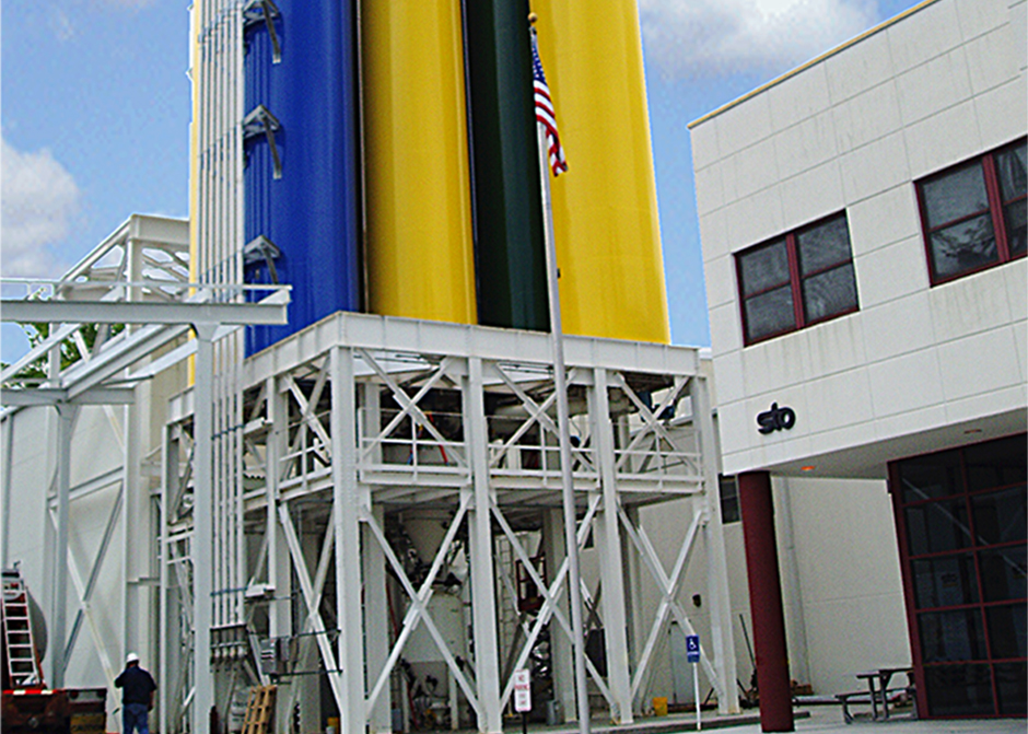 Weighing, batching and dense phase pneumatic conveying of synthetic stucco